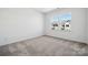 Bright bedroom with soft carpet, large windows, and neutral walls creates a cozy atmosphere at 3112 Beacon Heights Rd, Indian Land, SC 29707