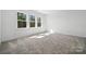 Sun-filled bedroom featuring soft carpet and large windows with views of the surrounding greenery at 3112 Beacon Heights Rd, Indian Land, SC 29707