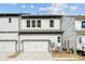 Well-maintained townhome featuring a two-car garage, modern siding, and charming curb appeal at 3112 Beacon Heights Rd, Indian Land, SC 29707