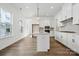 Bright, modern kitchen with white cabinets, stainless appliances, and pendant lighting at 3112 Beacon Heights Rd, Indian Land, SC 29707