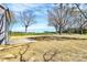 Spacious backyard with large trees and lush green grass on a sunny day at 4206 Old Monroe Marshville Rd, Wingate, NC 28174