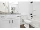 Modern bathroom features a vanity with a granite countertop, black hardware, and a tub-shower combo at 4206 Old Monroe Marshville Rd, Wingate, NC 28174