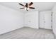 Bright bedroom with neutral color scheme features a ceiling fan, closet and doorway at 4206 Old Monroe Marshville Rd, Wingate, NC 28174