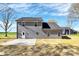 View of home featuring gray siding, concrete patio, and a lush yard at 4206 Old Monroe Marshville Rd, Wingate, NC 28174