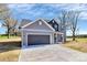 Charming two-story home with gray siding, dark gray garage door and long driveway at 4206 Old Monroe Marshville Rd, Wingate, NC 28174