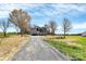 Exterior view of gray two-story home with a long gravel driveway at 4206 Old Monroe Marshville Rd, Wingate, NC 28174