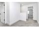 Well-lit hallway features neutral carpet and white trim, with an open doorway leading to another room at 4206 Old Monroe Marshville Rd, Wingate, NC 28174