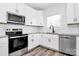 Well-lit kitchen featuring white cabinets, stainless steel appliances, granite countertops, and subway tile backsplash at 4206 Old Monroe Marshville Rd, Wingate, NC 28174