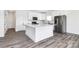 Bright kitchen boasts white cabinets, stainless steel appliances, and a granite island, seamlessly blending style and functionality at 4206 Old Monroe Marshville Rd, Wingate, NC 28174