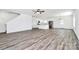 Open-concept living space with wood-look floors, connecting the living room, kitchen, and dining area for seamless living at 4206 Old Monroe Marshville Rd, Wingate, NC 28174
