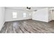 Spacious living room with wood-look flooring, bright windows, and a modern ceiling fan for comfortable living at 4206 Old Monroe Marshville Rd, Wingate, NC 28174