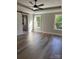 Sunlit primary bedroom featuring luxury vinyl plank flooring, ceiling fan, and barn door to the en suite bath at 59 Browning Dr, Taylorsville, NC 28681