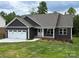 Charming home with a 2-car garage, inviting front porch, and well-manicured lawn at 59 Browning Dr, Taylorsville, NC 28681