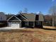 New construction home features a covered front porch, two-car garage and a professionally landscaped front yard at 59 Browning Dr, Taylorsville, NC 28681