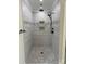 Modern shower featuring neutral gray tiles and a rainfall showerhead with seat at 59 Browning Dr, Taylorsville, NC 28681