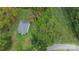 An aerial view shows a quaint home nestled in a serene, wooded area, offering privacy and natural beauty at 113 Fairview St, Clover, SC 29710