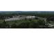 An aerial view of a commercial building next to baseball field surrounded by trees, blending urban and recreational spaces at 113 Fairview St, Clover, SC 29710