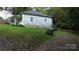 The side of a single-story home is shown with a grassy yard and driveway, featuring simple yet functional design at 113 Fairview St, Clover, SC 29710
