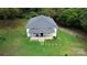 Charming single-story home with a classic front porch, surrounded by a lush green lawn and mature trees at 113 Fairview St, Clover, SC 29710