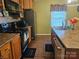 Traditional kitchen featuring wooden cabinets, modern appliances, and stylish accents, creating a warm and inviting space at 113 Fairview St, Clover, SC 29710