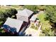 Aerial view of the property showcasing the large roof, screened porch, garage, and the surrounding greenery at 102 Sleaford Ct, Dallas, NC 28034