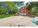 The home's backyard features a brick exterior, rear patio and garden, and driveway to the detached garage at 102 Sleaford Ct, Dallas, NC 28034
