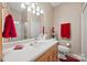 Bathroom featuring wood cabinetry, large mirror, and modern toilet at 102 Sleaford Ct, Dallas, NC 28034
