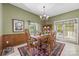 Inviting dining room featuring natural light, traditional furniture, and access to the backyard at 102 Sleaford Ct, Dallas, NC 28034