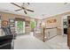 Upstairs hallway featuring railing, neutral paint, carpet, and a ceiling fan at 102 Sleaford Ct, Dallas, NC 28034