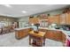 Open-concept kitchen featuring wooden cabinetry, white countertops, and an island work station at 102 Sleaford Ct, Dallas, NC 28034