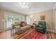 Comfortable living room with a sofa, recliner, hardwood floors and an area rug at 102 Sleaford Ct, Dallas, NC 28034
