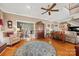 Spacious living room with hardwood floors, ceiling fan and view into the dining and stairway at 102 Sleaford Ct, Dallas, NC 28034
