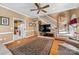Open living room featuring hardwood floors, a staircase, and an open view into the kitchen at 102 Sleaford Ct, Dallas, NC 28034