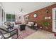 Cozy screened porch features brick accents, comfortable seating and fan at 102 Sleaford Ct, Dallas, NC 28034
