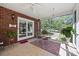 Enclosed porch with brick wall and tile floor, perfect for enjoying the outdoors at 102 Sleaford Ct, Dallas, NC 28034