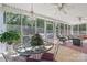 Bright sunroom with tiled floors, ceiling fans, and plants at 102 Sleaford Ct, Dallas, NC 28034