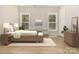 Cozy bedroom with two windows, a wooden bed frame, and soft neutral tones at 1025 Baylor Grove Rd, Monroe, NC 28112