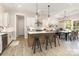 Bright kitchen features an island with bar seating, modern lighting, and an adjacent dining area at 1025 Baylor Grove Rd, Monroe, NC 28112