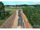 Level view of a new road winding through the wooded area at 1025 Baylor Grv, Monroe, NC 28112