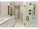 Bathroom showcasing a glass shower with dual shower heads and double vanity at 1025 Baylor Grv, Monroe, NC 28112