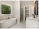 Bright bathroom with a soaking tub, walk-in shower, and double vanity at 1025 Baylor Grv, Monroe, NC 28112