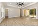 Bright bedroom with wood floors, tray ceiling, and sliding doors to covered patio at 1025 Baylor Grv, Monroe, NC 28112