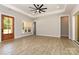 Bedroom featuring wood floors, large windows, tray ceiling, and glass panel door at 1025 Baylor Grv, Monroe, NC 28112