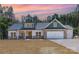 Charming home with stone accents, attached two car garage and beautiful sunset backdrop at 1025 Baylor Grv, Monroe, NC 28112