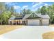 Charming home with stone accents, attached two-car garage, and long concrete driveway at 1025 Baylor Grv, Monroe, NC 28112