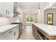 Kitchen with an island, stainless steel appliances, custom range hood, white cabinets, and quartz countertops at 1025 Baylor Grv, Monroe, NC 28112