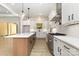 Bright kitchen features a large island, stainless appliances, and ample counter space at 1025 Baylor Grv, Monroe, NC 28112