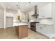 Kitchen with island, stainless steel appliances, and white cabinets with white quartz countertops at 1025 Baylor Grv, Monroe, NC 28112