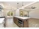 Eat-in kitchen with island featuring stainless steel appliances, white quartz countertops and stainless steel lighting fixtures at 1025 Baylor Grv, Monroe, NC 28112