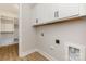 Convenient laundry room features overhead cabinets and storage with wood floors at 1025 Baylor Grv, Monroe, NC 28112